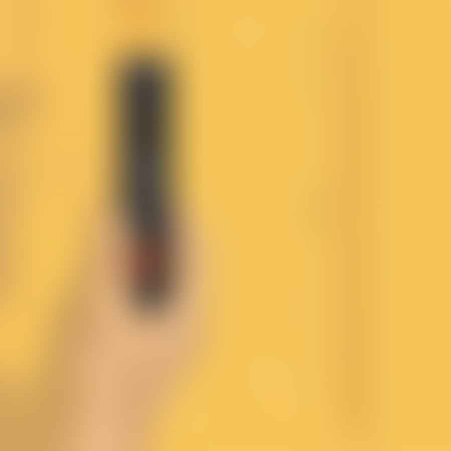 A hand using a stud finder on a wall, with pencil marks indicating the stud locations.